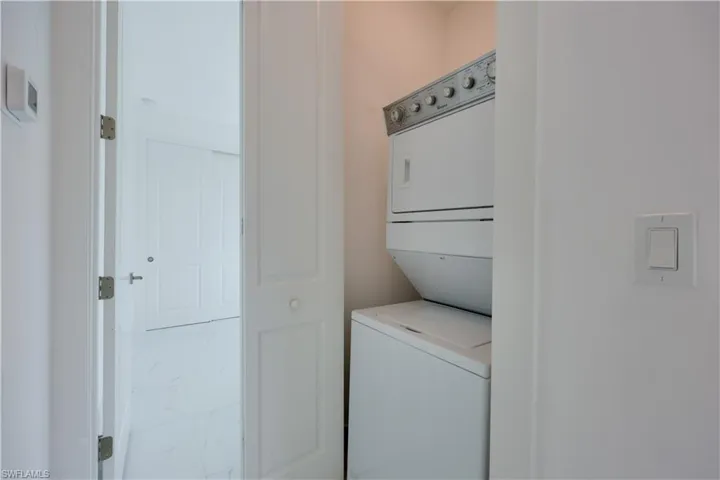 Laundry area featuring stacked washer / drying machine