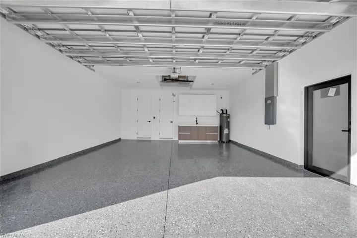 Garage with water heater and electric panel