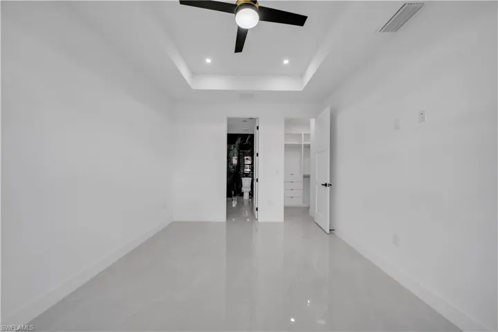 Spare room featuring ceiling fan, recessed lighting, and a tray ceiling