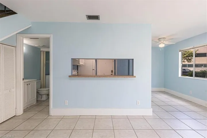 Living room with view toward the kitchen, 1/2 bath and laundry