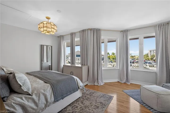 Bedroom with light wood-type flooring and multiple windows
