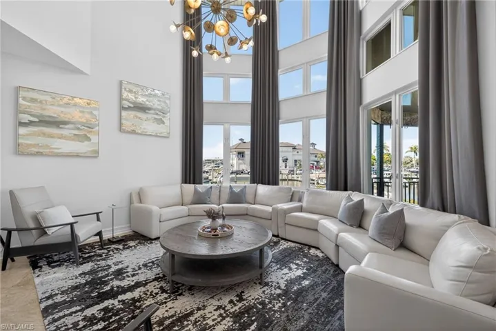Living area featuring a chandelier and a high ceiling
