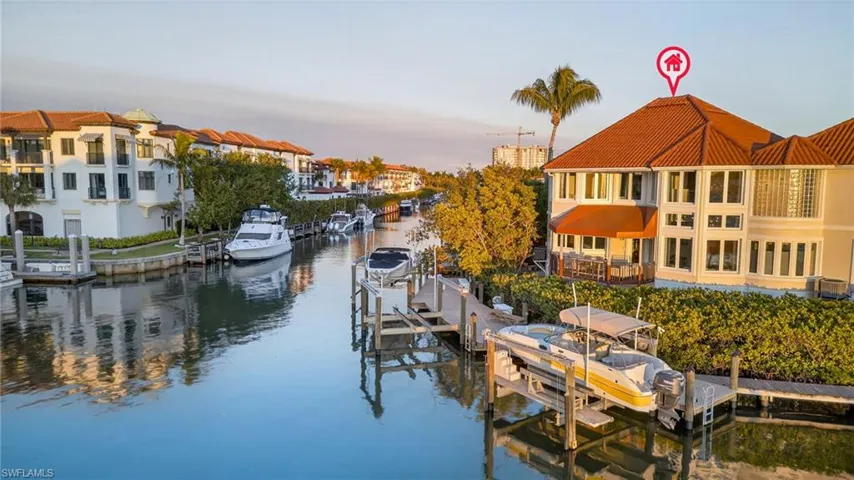 Dock area featuring boat lift and a water view