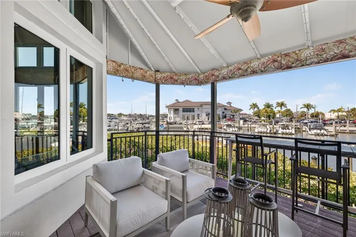 Balcony featuring a ceiling fan, a water view, and outdoor furniture