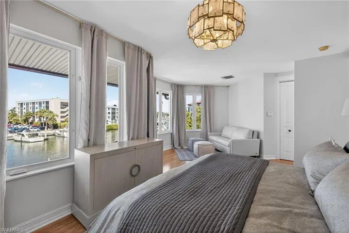Bedroom featuring a water view and light wood-style flooring