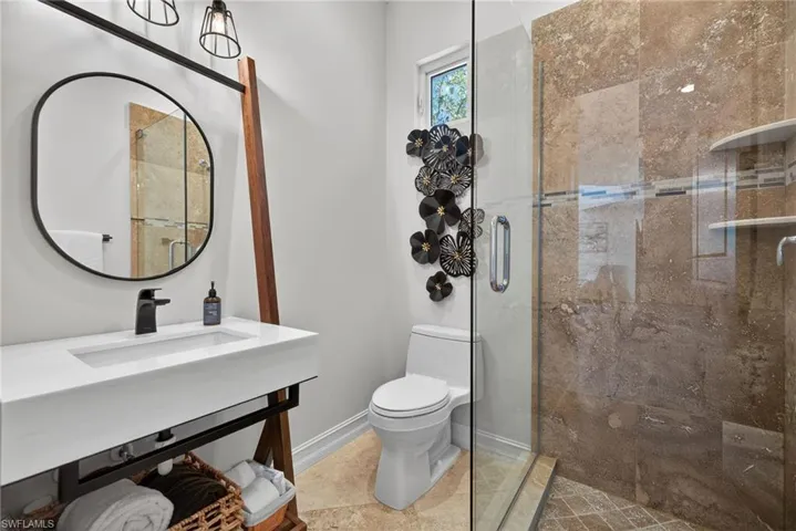 Bathroom with toilet and a stall shower
