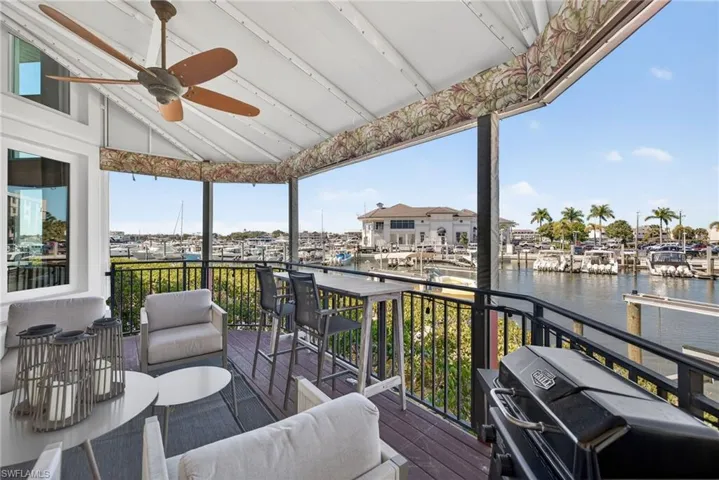 Deck featuring ceiling fan, area for grilling, a water view, and an outdoor living space