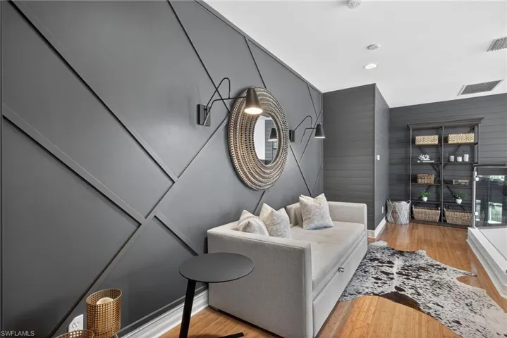 Living area featuring light wood finished floors and recessed lighting