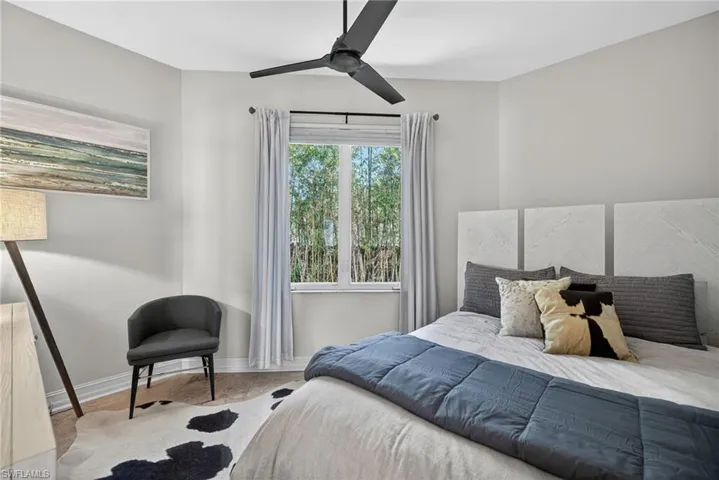 Bedroom featuring ceiling fan and baseboards