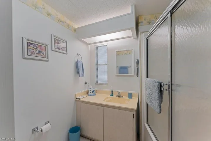Bathroom with a shower with door and vanity