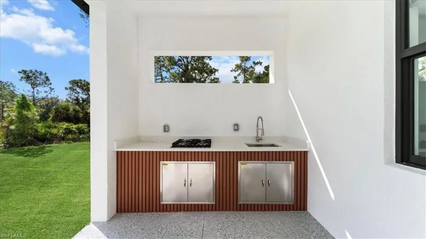 Bar featuring speckle patterned floor, healthy amount of natural light, and black gas stovetop
