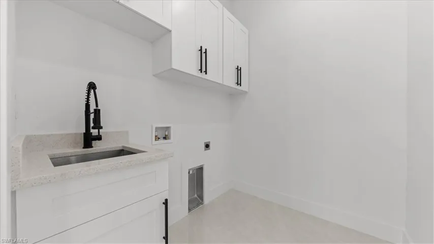 Laundry room featuring cabinet space, hookup for a washing machine, and hookup for an electric dryer