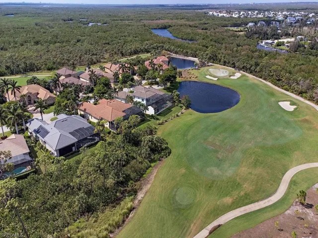 Birds eye view of property with a water view