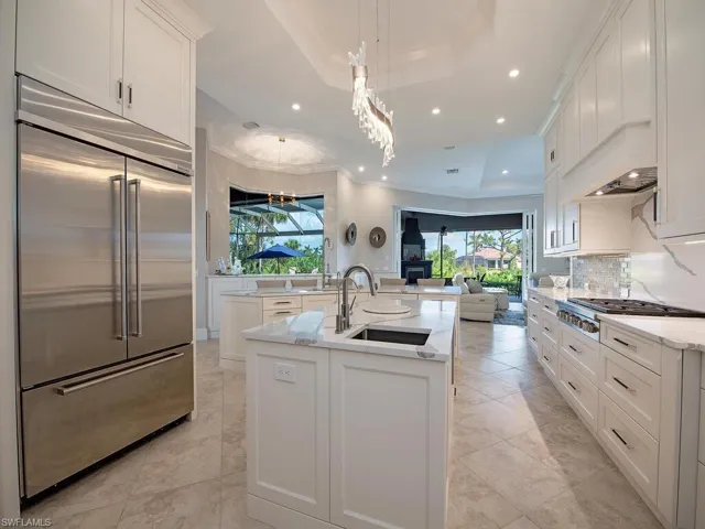 Kitchen with high end appliances, Wolf gas cooktop, separate island sink and plenty of counter space.