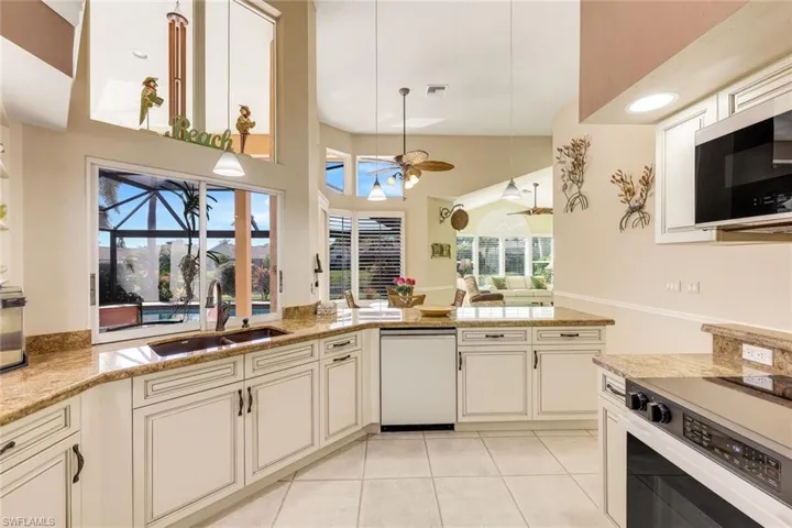 White cabinetry, quartz countertops, vaulted ceilings and so much more!