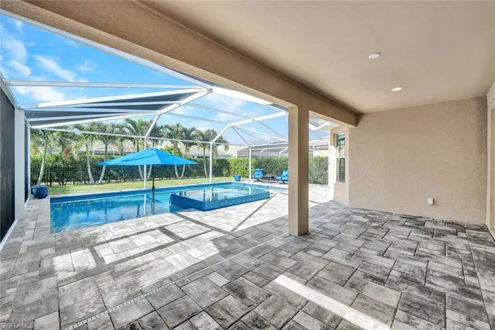 View of pool featuring a patio area and a lanai