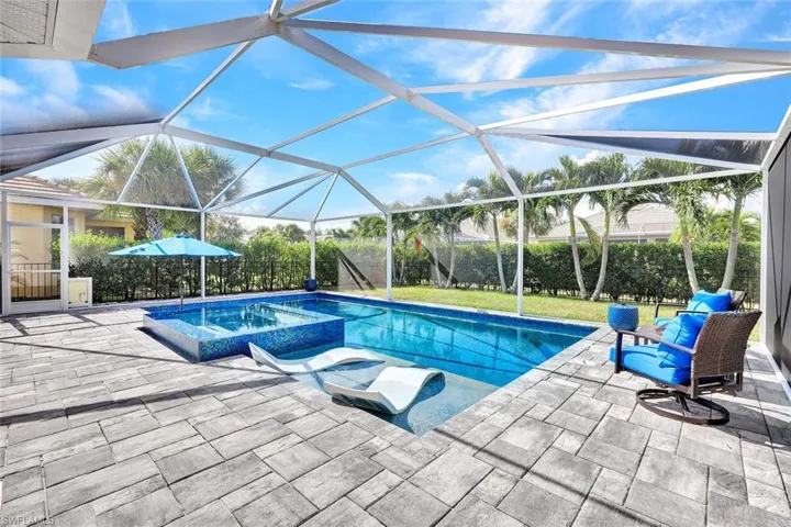 View of swimming pool with screen enclosure, and lovely Lanscaping for your privacy.