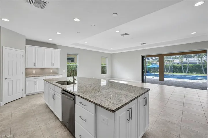 Kitchen has lots of cabinets and a walk-in pantry.