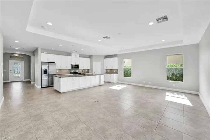 Great room has tile flooring, a tray ceiling, and a healthy amount of sunlight. Great for entertaining family and friends all in one space.