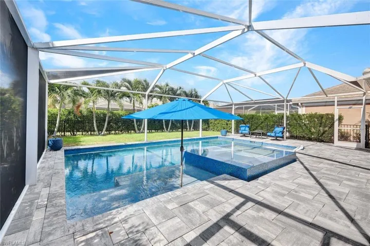 View of pool featuring a lanai, an in ground hot tub, and a patio area, with lots of space