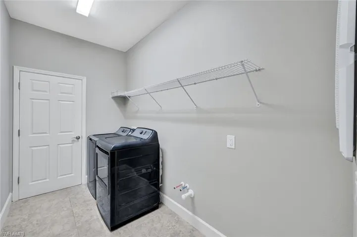 Laundry room area featuring washer and dryer and pre-plumb for a future laundry tub