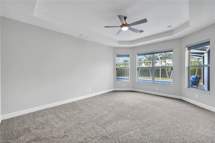 Primary room has bay window overlooking pool area and his and hers Walkin closets
