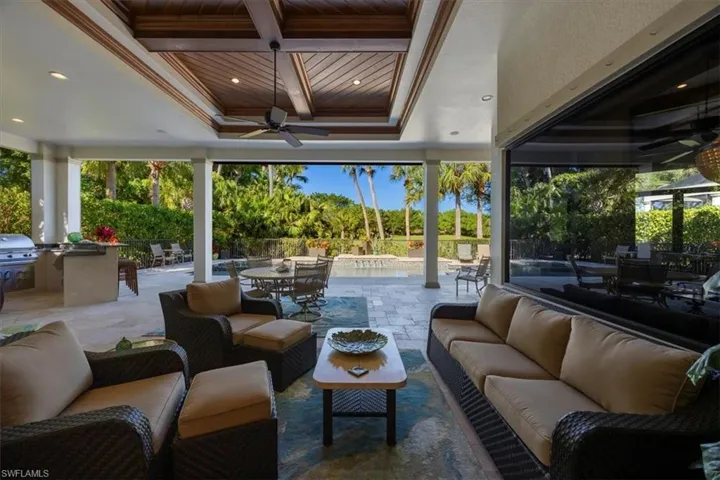 View of patio with outdoor dining space, a ceiling fan, and an outdoor living space