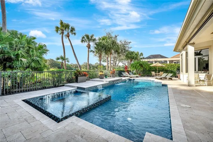 View of swimming pool featuring a patio and a pool with connected hot tub