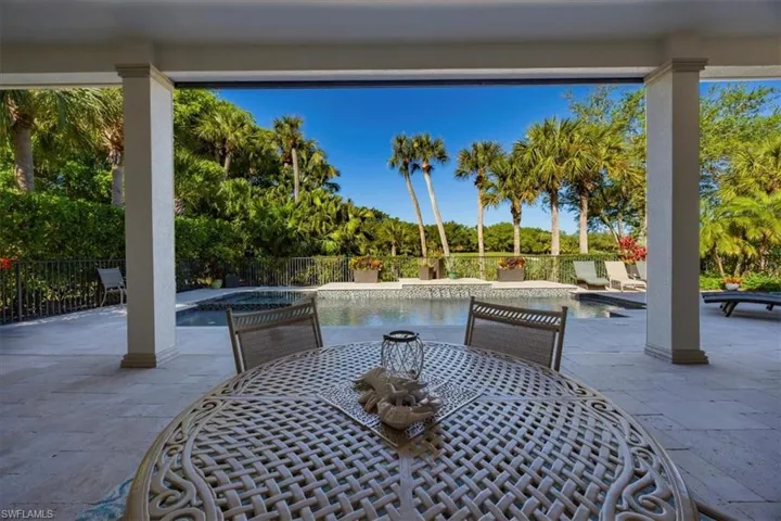 View of patio featuring an in-ground hot tub and outdoor dining area