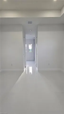 Hall featuring recessed lighting and light tile patterned floors