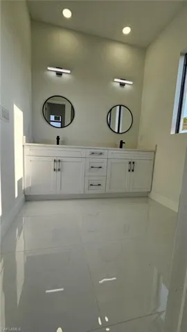 Full bathroom featuring double vanity and recessed lighting