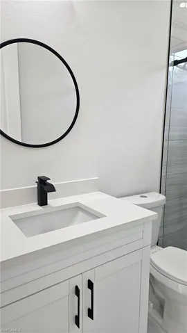 Full bath with vanity and a shower stall