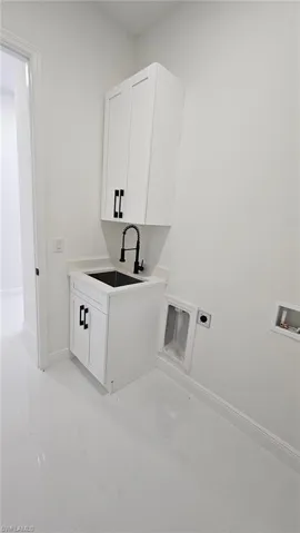Laundry area featuring cabinet space, hookup for a washing machine, and hookup for an electric dryer