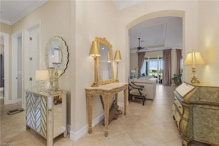 Hallway featuring tile patterned flooring and ornamental molding