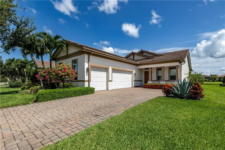 View of front of house featuring a garage and a front lawn