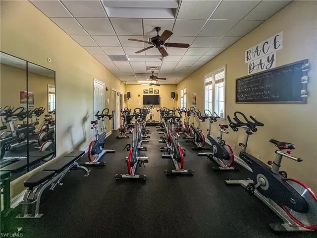 Gym featuring a paneled ceiling and ceiling fan