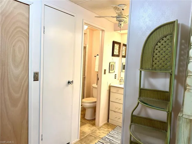 Bathroom featuring toilet and ceiling fan