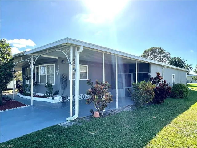 View of side of home with a lawn