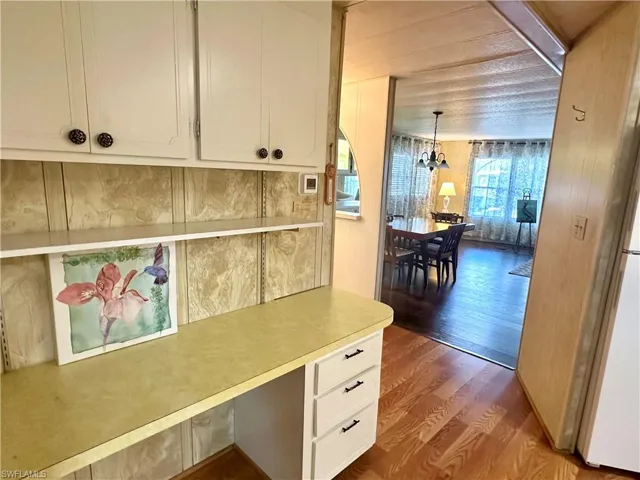 Den with built-in cabinets.