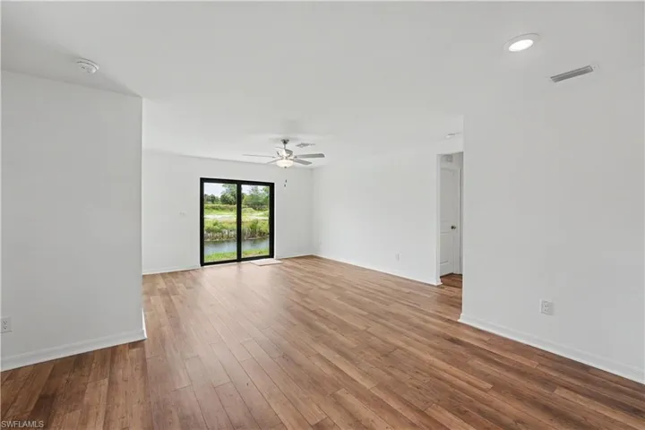 Spacious interior featuring wood-finish flooring and a ceiling fan