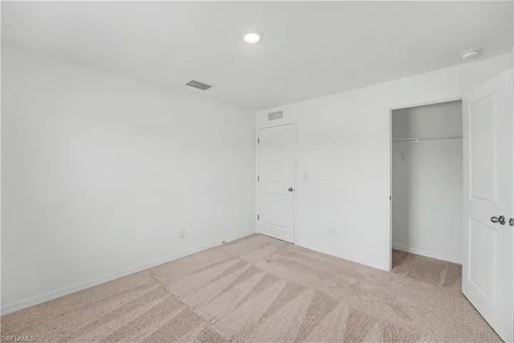 Neutral-toned wall-to-wall carpeting with a subtle pattern