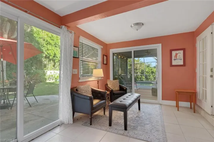 Sunroom featuring large sliding glass doors, ceramic tile flooring, and a multi-lite door.  Can also be used as an office.