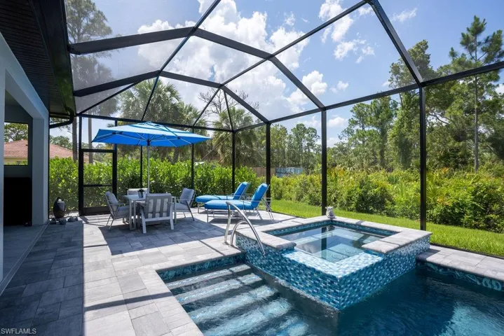 View of heated saltwater swimming pool/ spa featuring beautiful glass tile