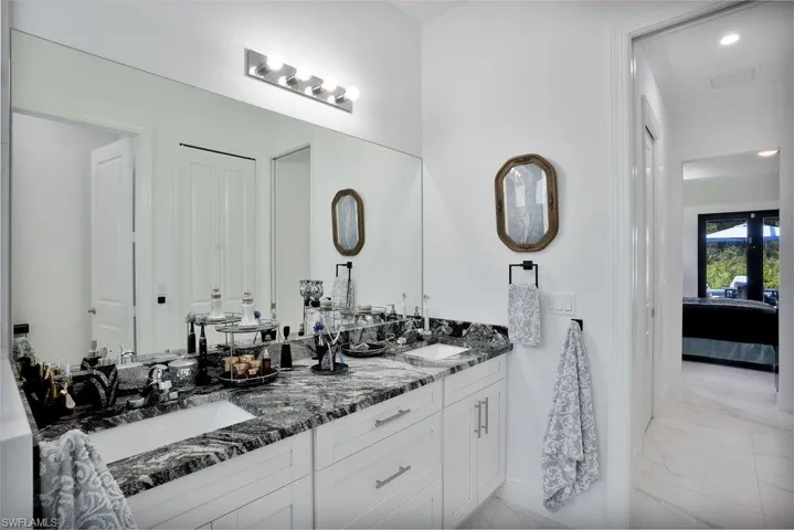 Primary bathroom showcasing a double vanity and tile floors