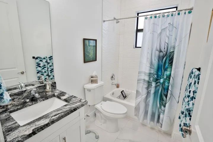 Full bathroom featuring tile floors, shower / bathtub combination