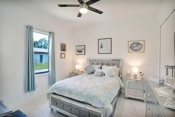 Tiled bedroom with ceiling fan