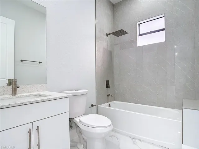 Full bathroom with shower / washtub combination, toilet, and vanity