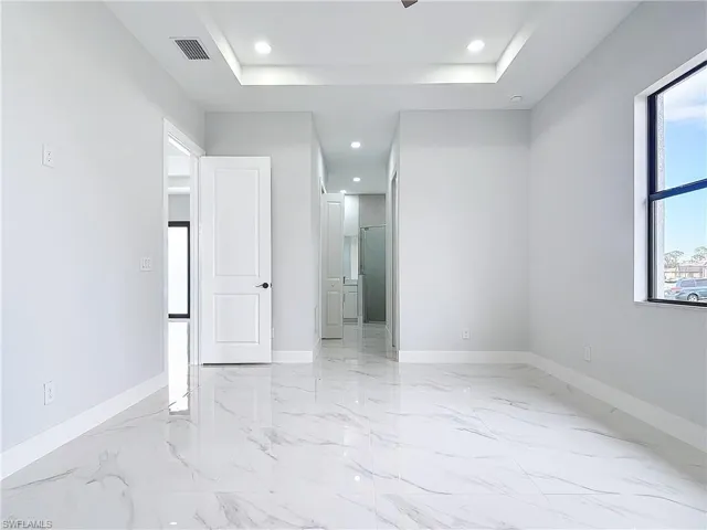 Unfurnished room featuring a raised ceiling