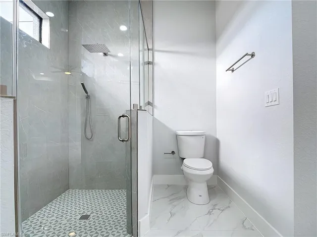 Bathroom featuring toilet and walk in shower