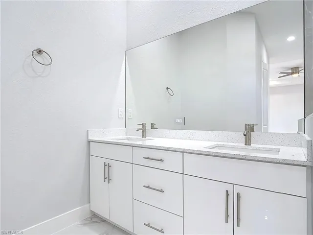 Bathroom with vanity and ceiling fan